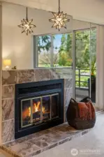 Primary Bedroom with Gas Fireplace & Mirrored Wall Exemplifing the Natural Lighting