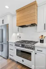 Bertazzoni 5-burner gas range with vent hood wrapped in white oak