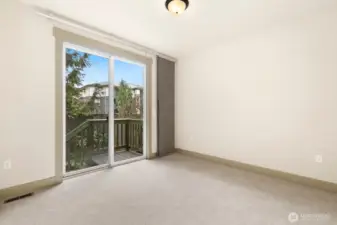 Main floor bedroom or office with access to back deck and patio