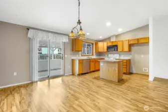 The dining room has a lot of space for your kitchen table and chairs, plus room for a desk if you wish. The island in the middle has extra storage space, and you're right by the sliding glass door that leads to the covered back porch.