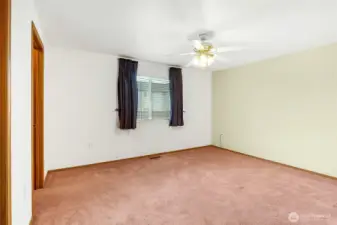 The primary bedroom has a generous size closet and a bathroom. This window faces the back yard.