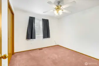 Bedroom #3 is toward the front of the house, right before the laundry room. The ceiling fan is included as well as the drapes and window blinds.