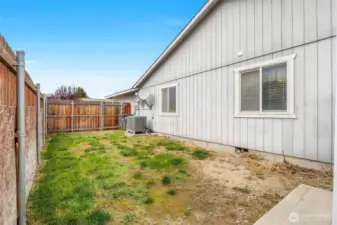 The right side of the house (behind the shed) has a walk-through gate by the heat pump.