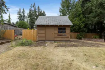 Large shed in backyard has a loft area with stairs for storage plus room for your garden tools! For you chicken lovers, the left side is a chicken coop or extra space for your imagination!