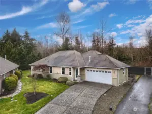 Ample driveway parking. Blacktop path to the right leads to community gate and walking trails.