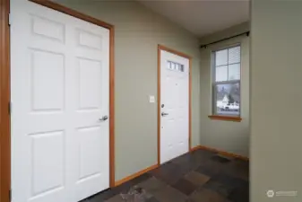 Entry with tile flooring and coat closet.