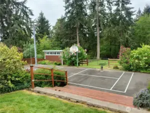 Sports court looking westerly. Note one of two outbuildings on property.