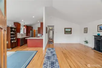 Entrance to home showing living room on the right, dining/kitchen on the left