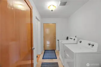 Laundry room with heated tile floors, door to garage