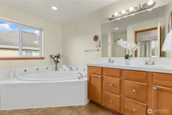 His and her sinks in addition to soaking tub