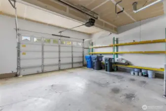 2 car garage with a workspace and shelving - both are included in sale!