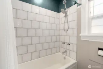 Updated Full bath on the main level has brand new tile tub surround