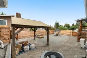 Backyard patio space is full fenced
