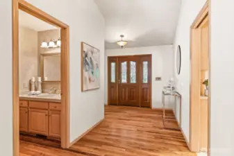 Beautiful leaded glass entry door; at left is the powder room, to the right is the kitchen.