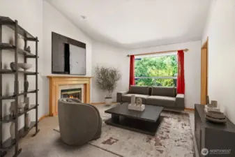 Digitally staged, the living room offers quiet conversation, filled with natural light.