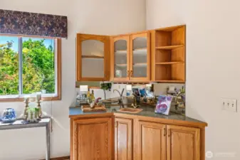 Wet bar with mini- refrigerator in the corner of the family room