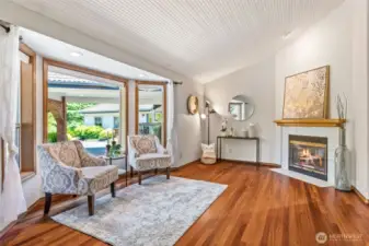 Primary suite sitting area with 3rd fireplace, gas insert, Cherry hardwood floor.