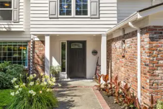 Charming entry with brick detailing and fresh landscaping sets the tone for a warm welcome.