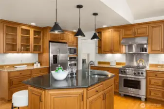 Top-of-the-line appliances, ample workspace, and warm wood accents create your perfect kitchen space.