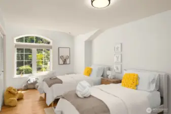 This secondary bedroom is filled with light and charm. Flexible in design, it can serve as a guest room, nursery, or creative space.