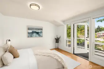 This bedroom offers vaulted ceilings and a calming view of the garden. It’s a restful retreat that feels both spacious and intimate.