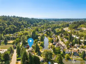 This aerial captures the rare combination of waterfront access and lush landscape. The property stretches wide, framed by natural beauty in every direction.