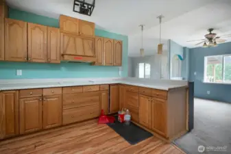 Kitchen looking into dining room, living room and front door.