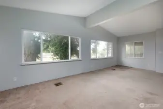Living room with vaulted ceiling.