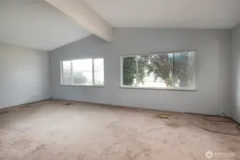 Living room windows look out toward side yard.