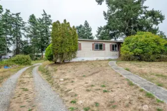 Front view with driveway and walkway to front porch.