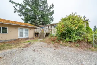 Main house on right with detached space on left in the backyard.