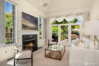 Living room with views of golf course and a cozy gas fireplace.