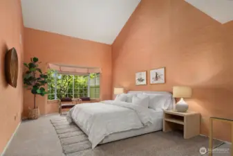 Large first floor primary suite with vaulted ceilings.