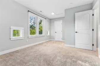 Bedroom #1 with view of walk-in closet behind door on left