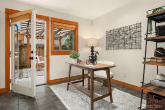 Versatile lower-level bedroom/office leading to the back patio.