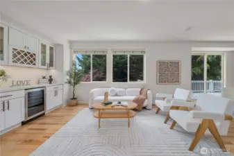 A sun-drenched main-level living room features a warm gas fireplace, creating an inviting and elegant space.