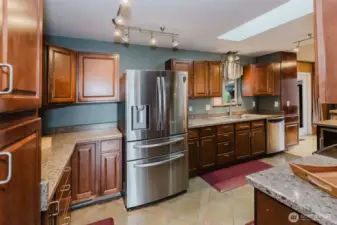 Remodeled kitchen featuring updated cabinetry, stainless steel refrigerator, and tile flooring.