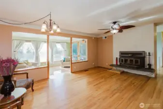 Sunroom filled with natural light, ideal for year-round enjoyment.fireplace focal point.