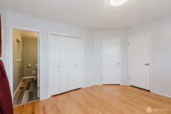 Primary bedroom with dual closets and adjoining updated half bath.