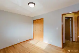 Secondary bedroom with closet storage and updated finishes.