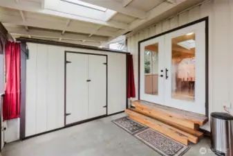 Covered patio area with built-in storage shed and backyard access.