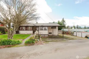 Fenced backyard with lawn and covered patio access.