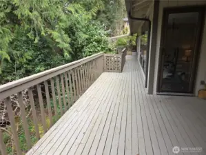 The deck runs the back of the house to the primary bedroom deck