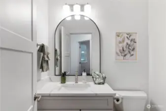 The convenient main floor Half Bathroom features an attractive vanity with quartz counter.