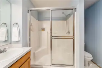 Large shower with built in seats and shelves.
