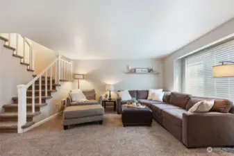 This sectional and "chair-and-a-half" fit easily in the space! Stairs lead to the bedrooms.