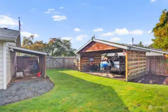 Two covered sheds perfect for gardening equipment and extra toys!