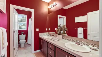 The full hall bath has tile floors and counters with a back splash.  2 sinks and plenty of drawers and storage.