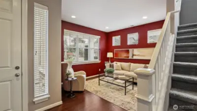 The living room or den has lots of natural light pouring into the room.