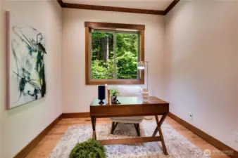 Downstairs den with wooded views.